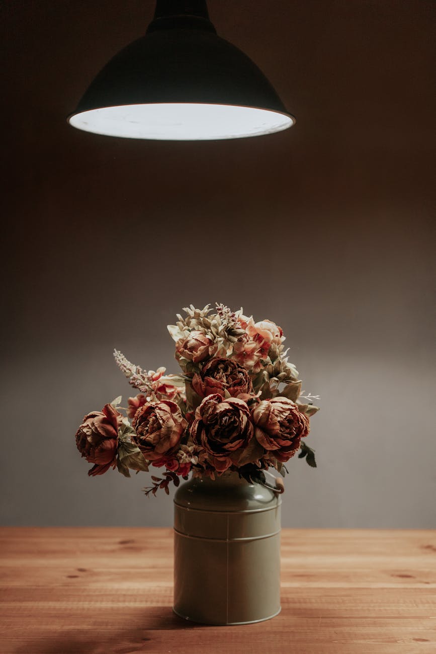 red and white flowers on gray steel vase